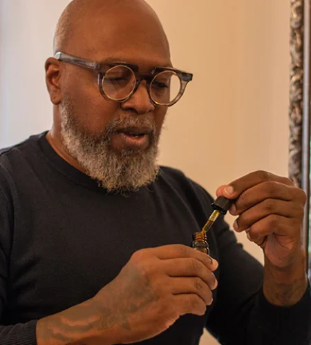Inner Beauty MD man taking tincture dose